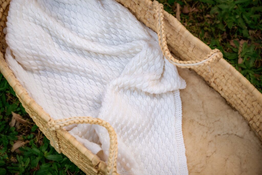 Bespoke baby blanket lying in moses basket by etsy store Yarnply
