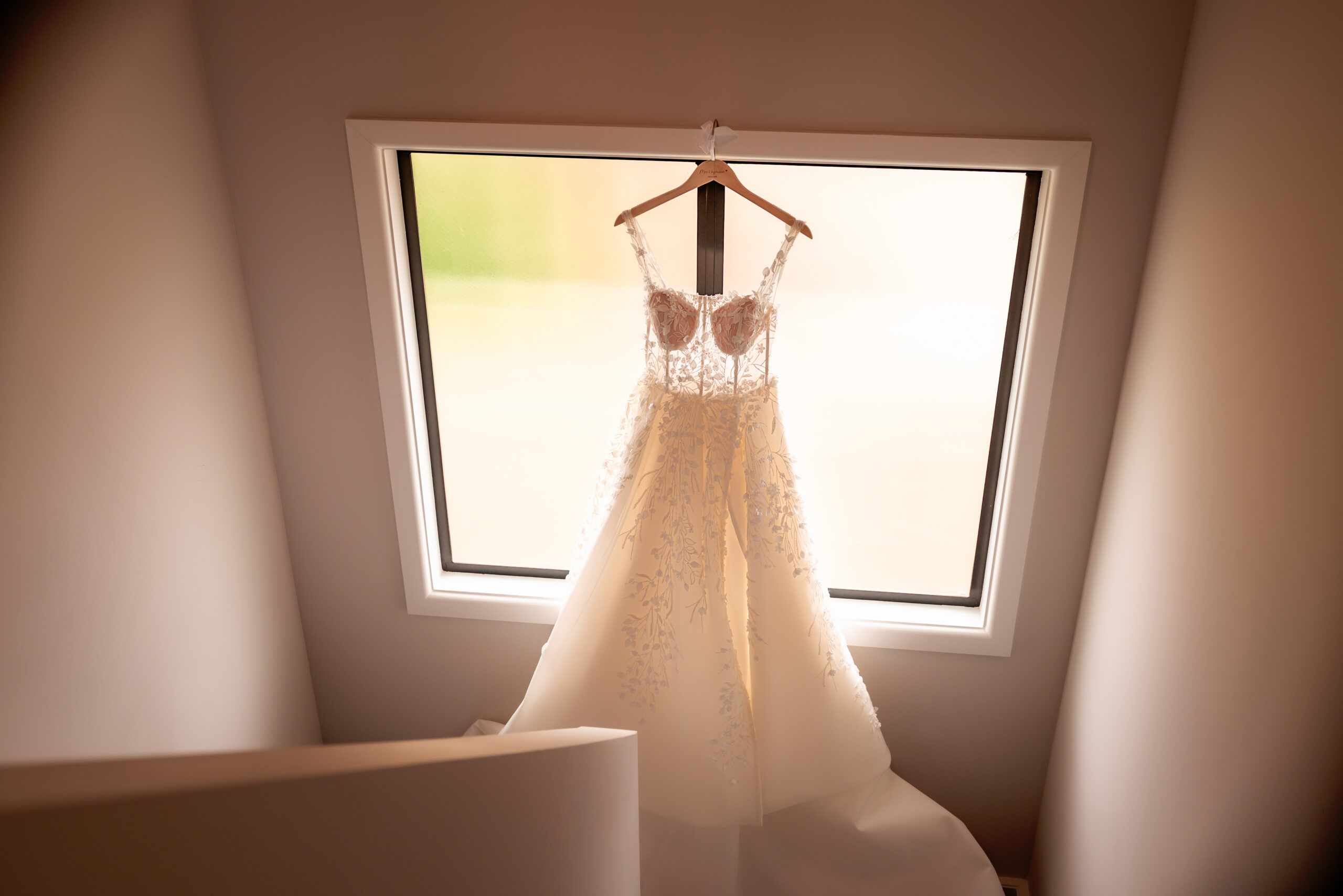 Bride's dress hanging in window
